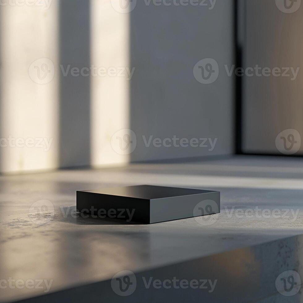 A black box sitting on a table in front of a window photo
