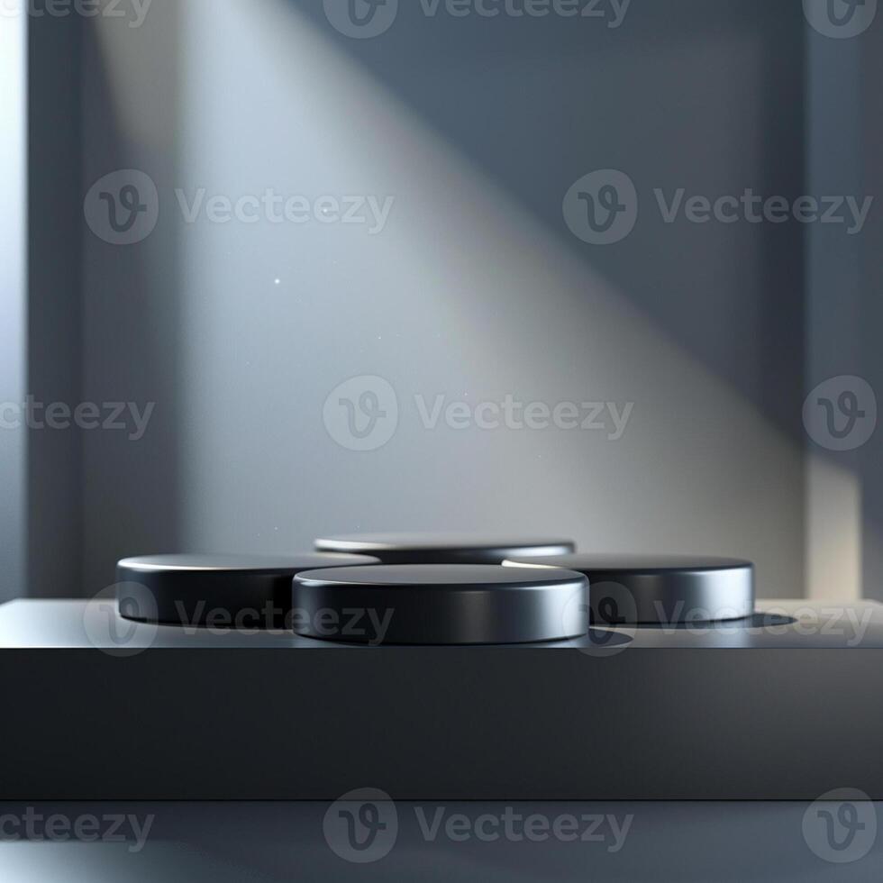 Three black round objects on a table in front of a wall photo