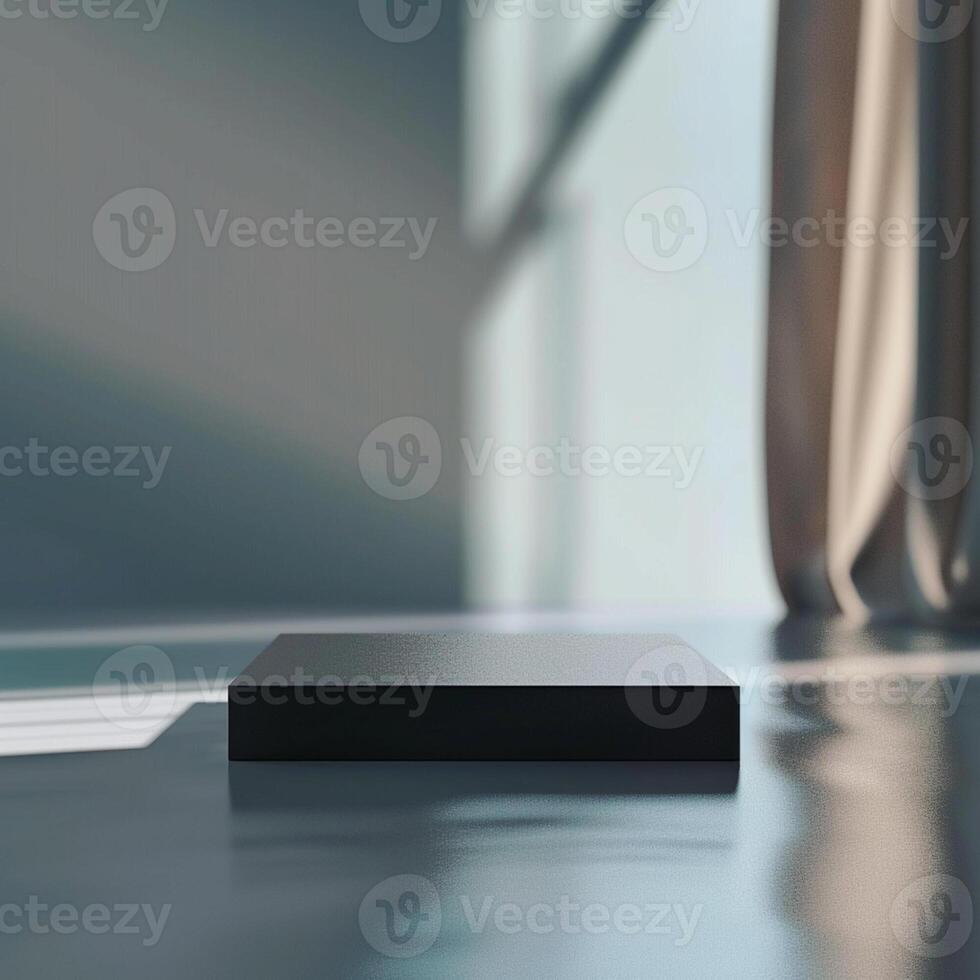 A black box sitting on a table in front of a window photo
