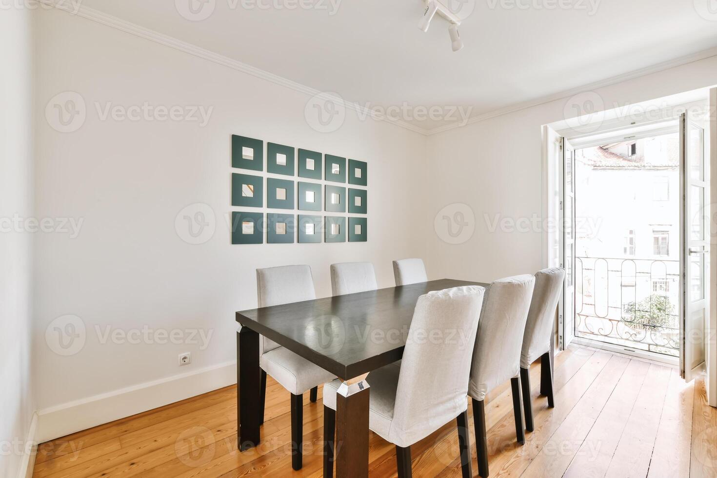 A dining room with a table and chairs photo
