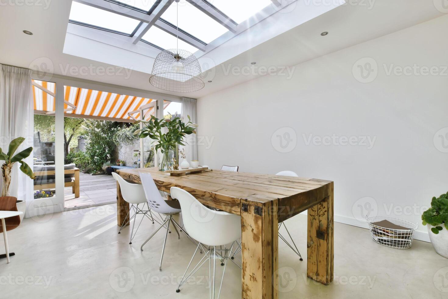 A dining room with skylights and a table photo