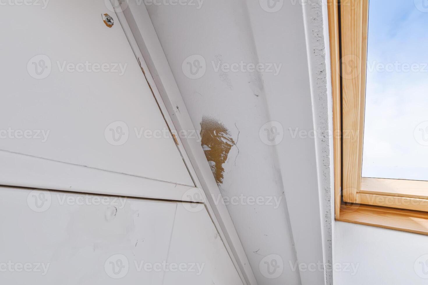 A white wall with a broken window and a broken window photo