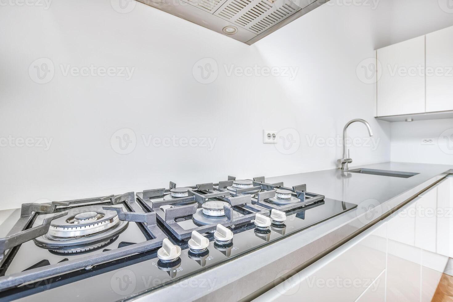 A kitchen with a stove and sink photo