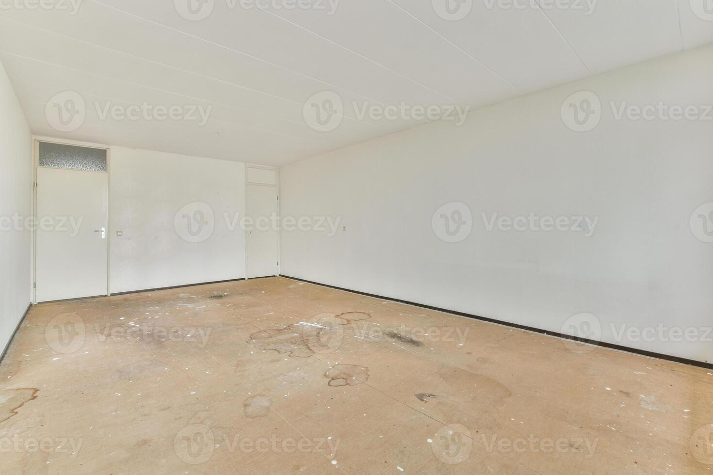 An empty room with a white wall and a door photo