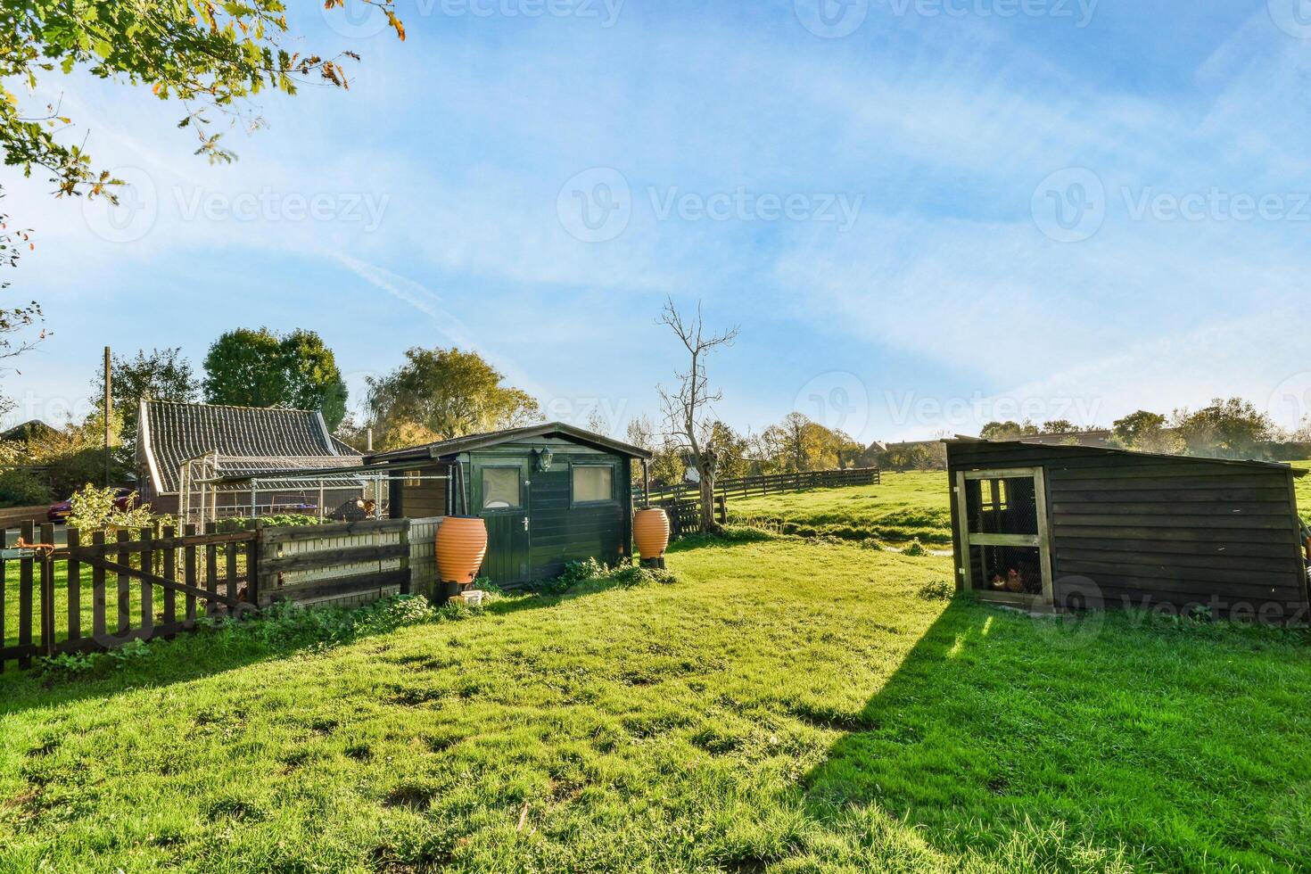A small wooden house with a garden and a barn photo