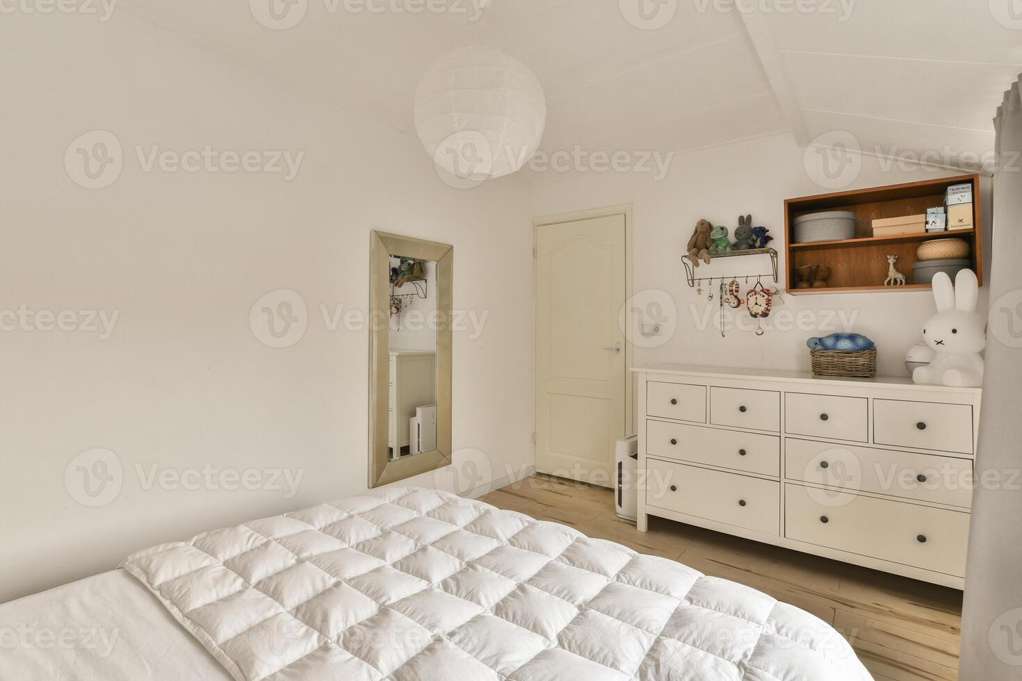 A bedroom with a white bed and a dresser photo