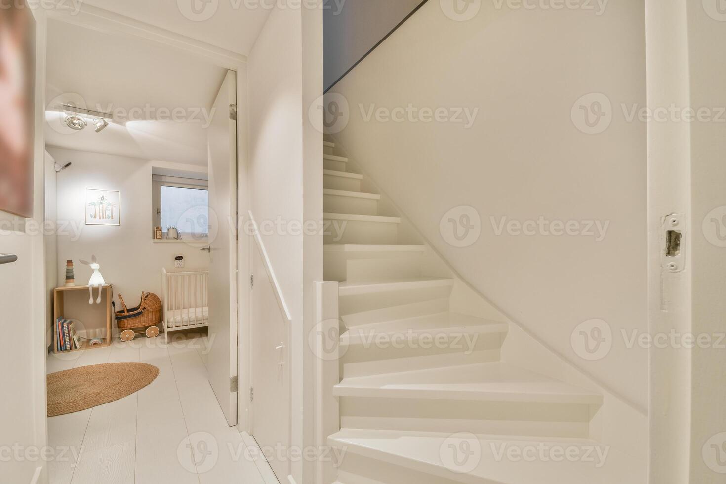 A white stairway leads to a room with a white door photo