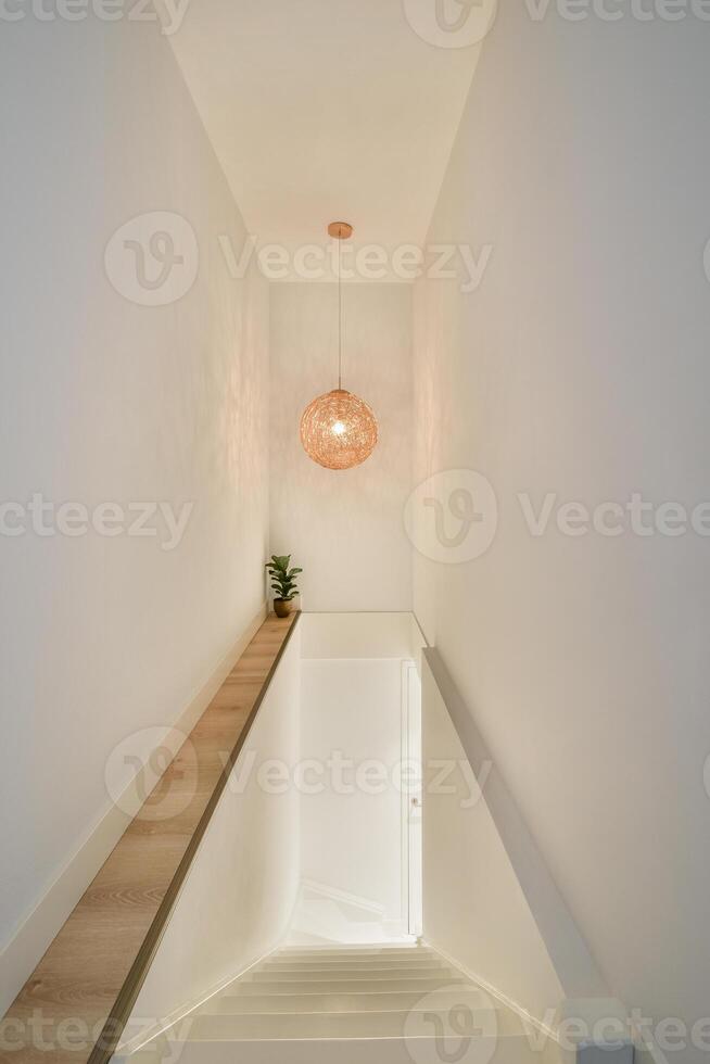 A staircase with a light hanging from the ceiling photo