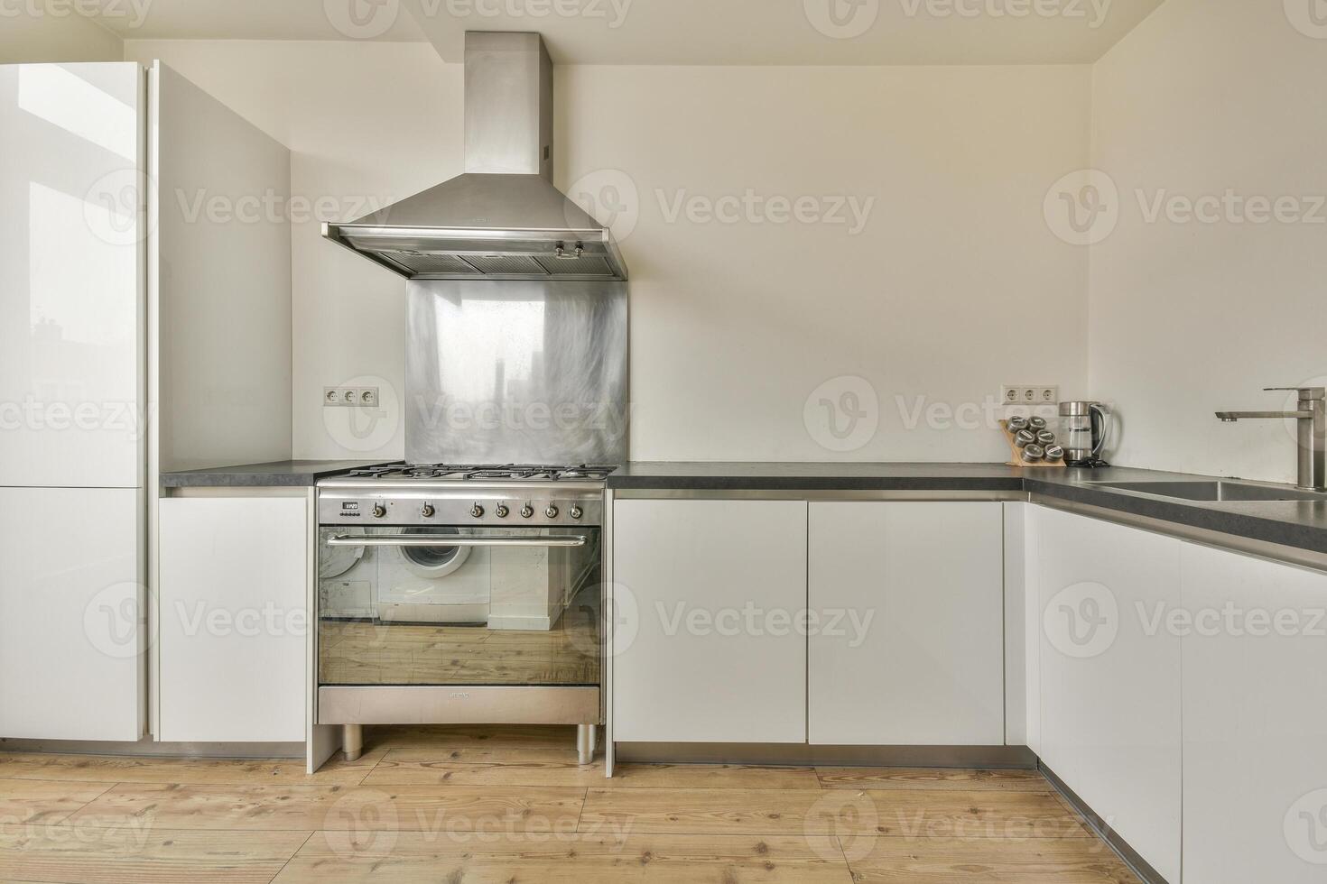 A kitchen with a stove and oven photo