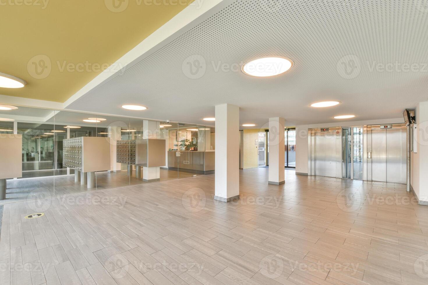 A large empty room with yellow walls and wooden floors photo