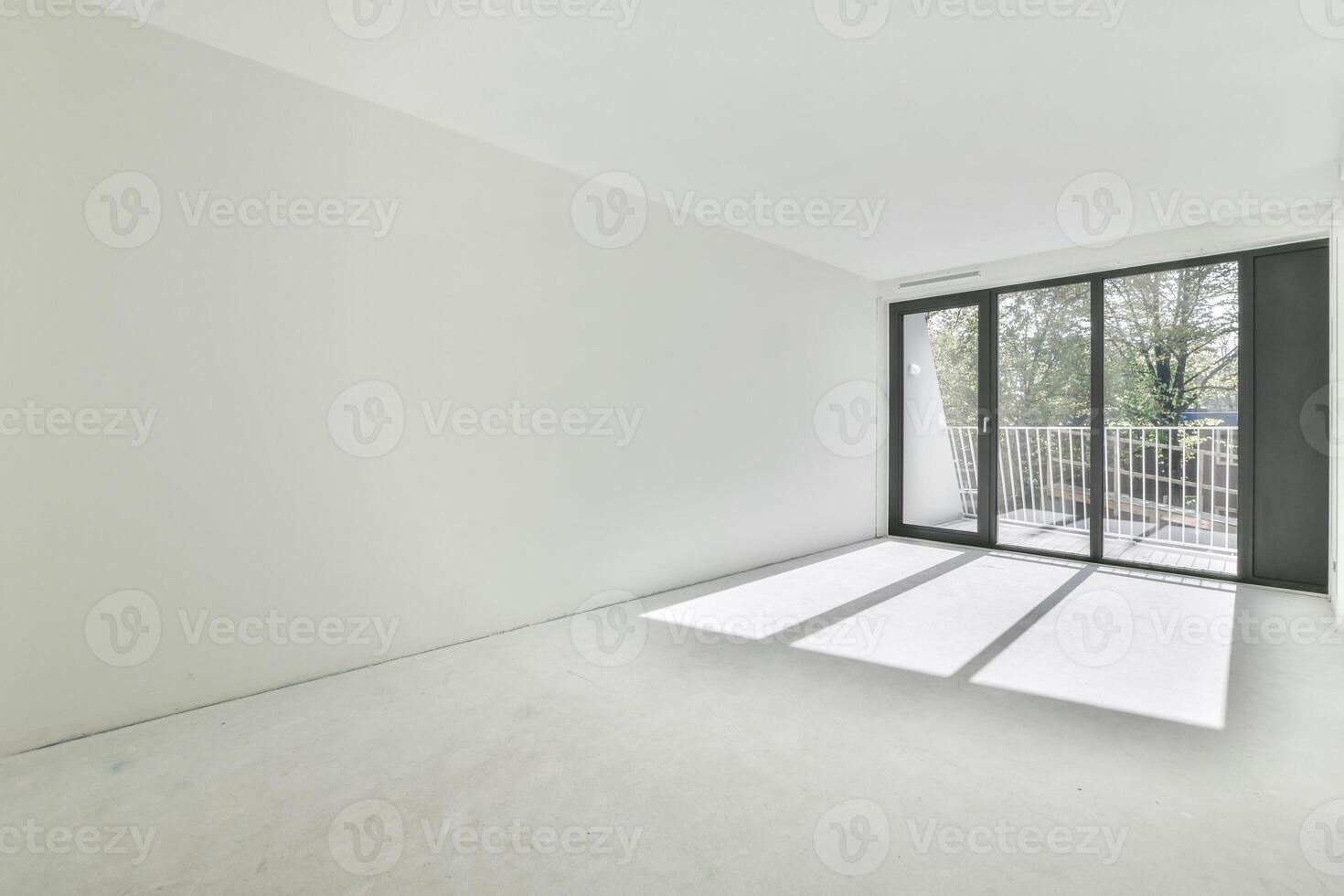 Empty room with large windows and white walls photo