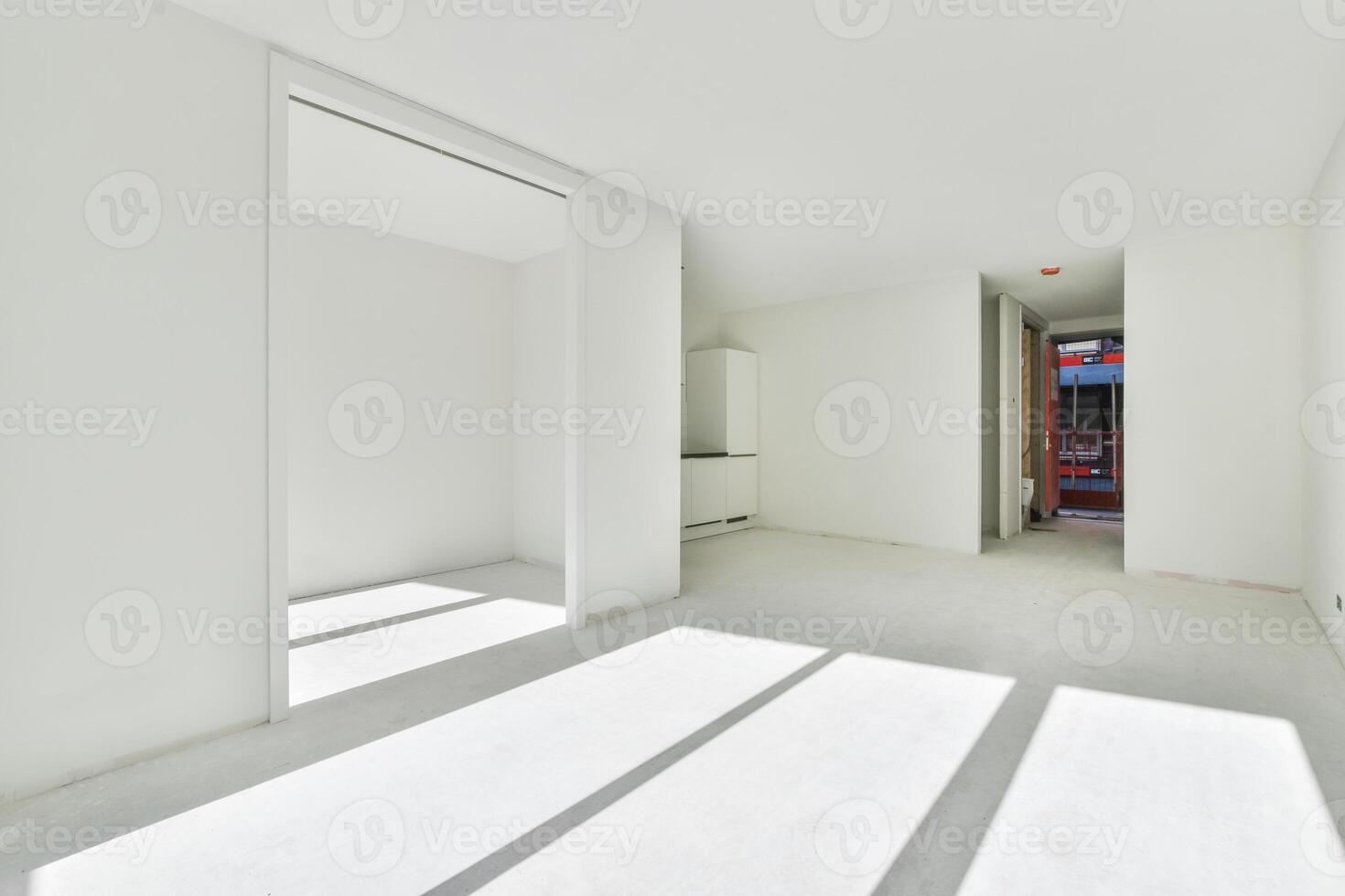 An empty room with white walls and a door photo
