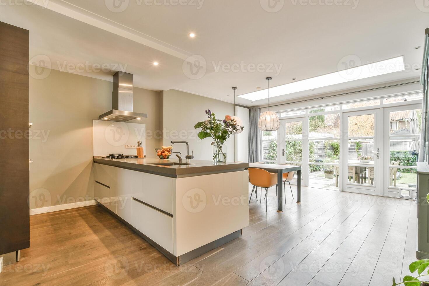 A kitchen with a large island and wooden floors photo