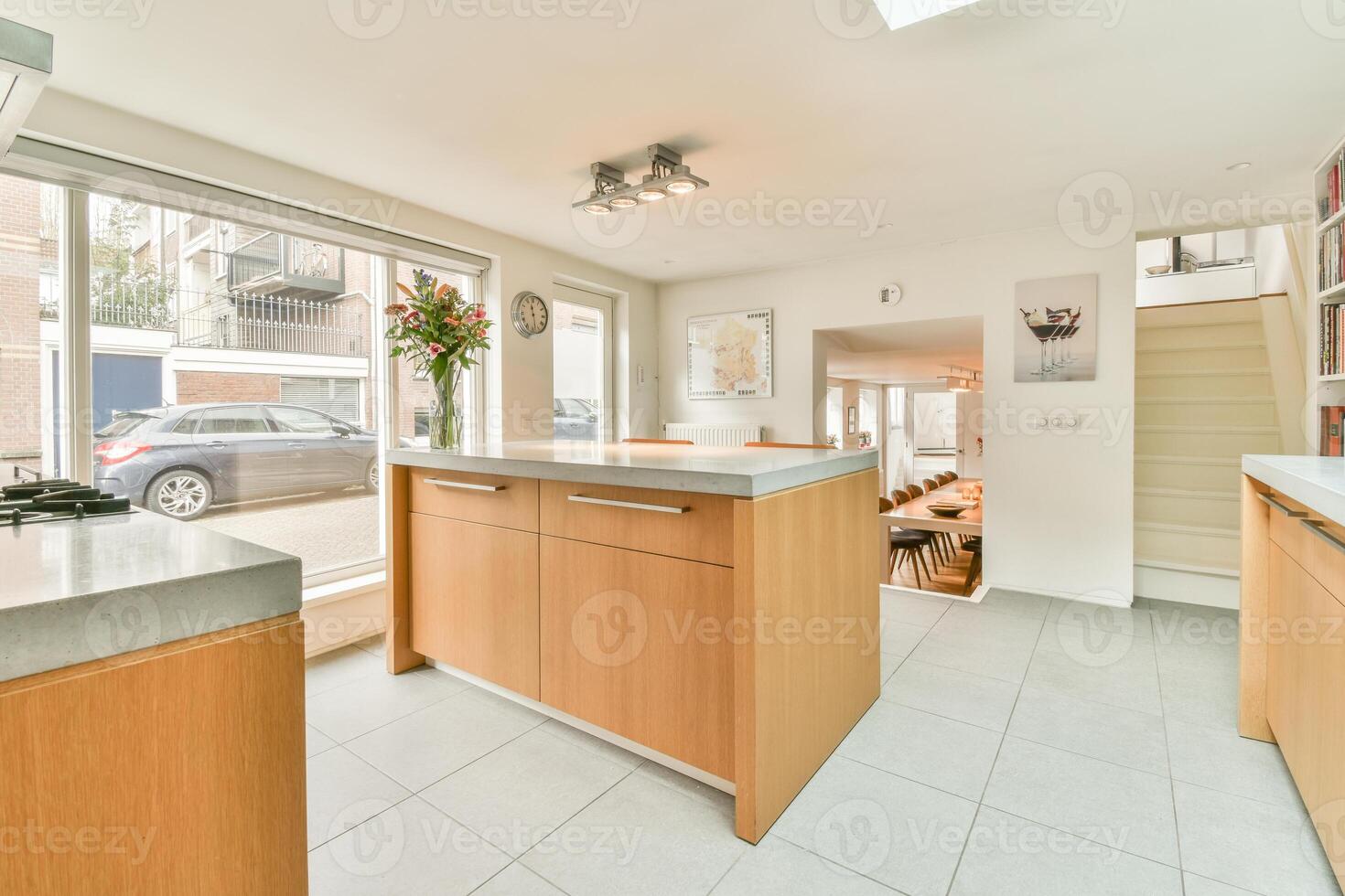 A kitchen with a large island and a window photo