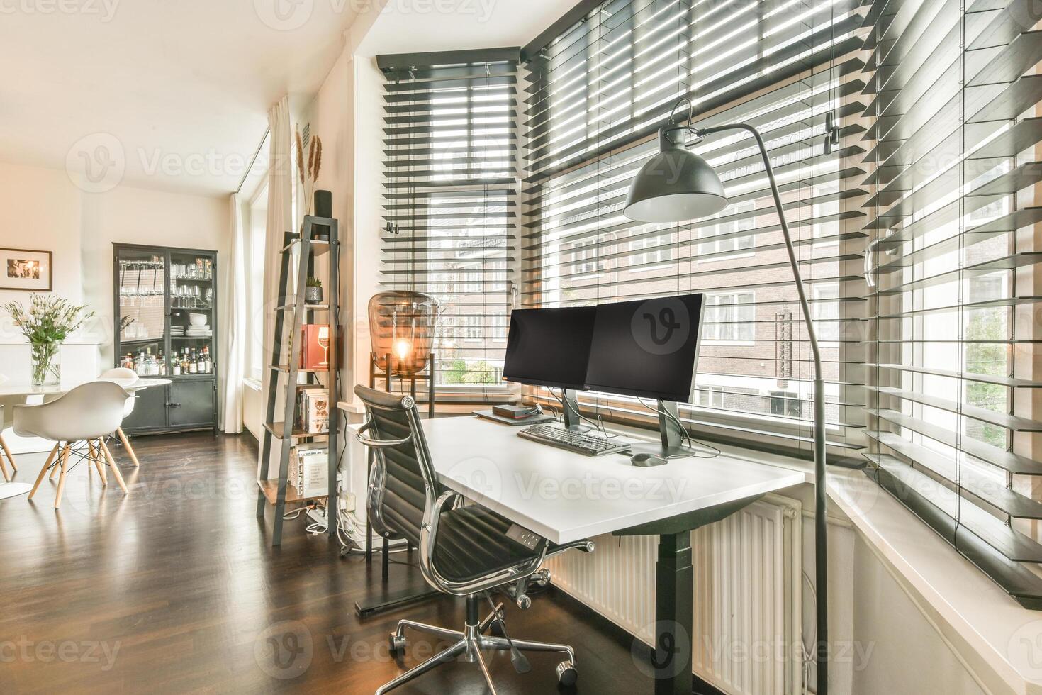 A home office with a desk, chair and window photo