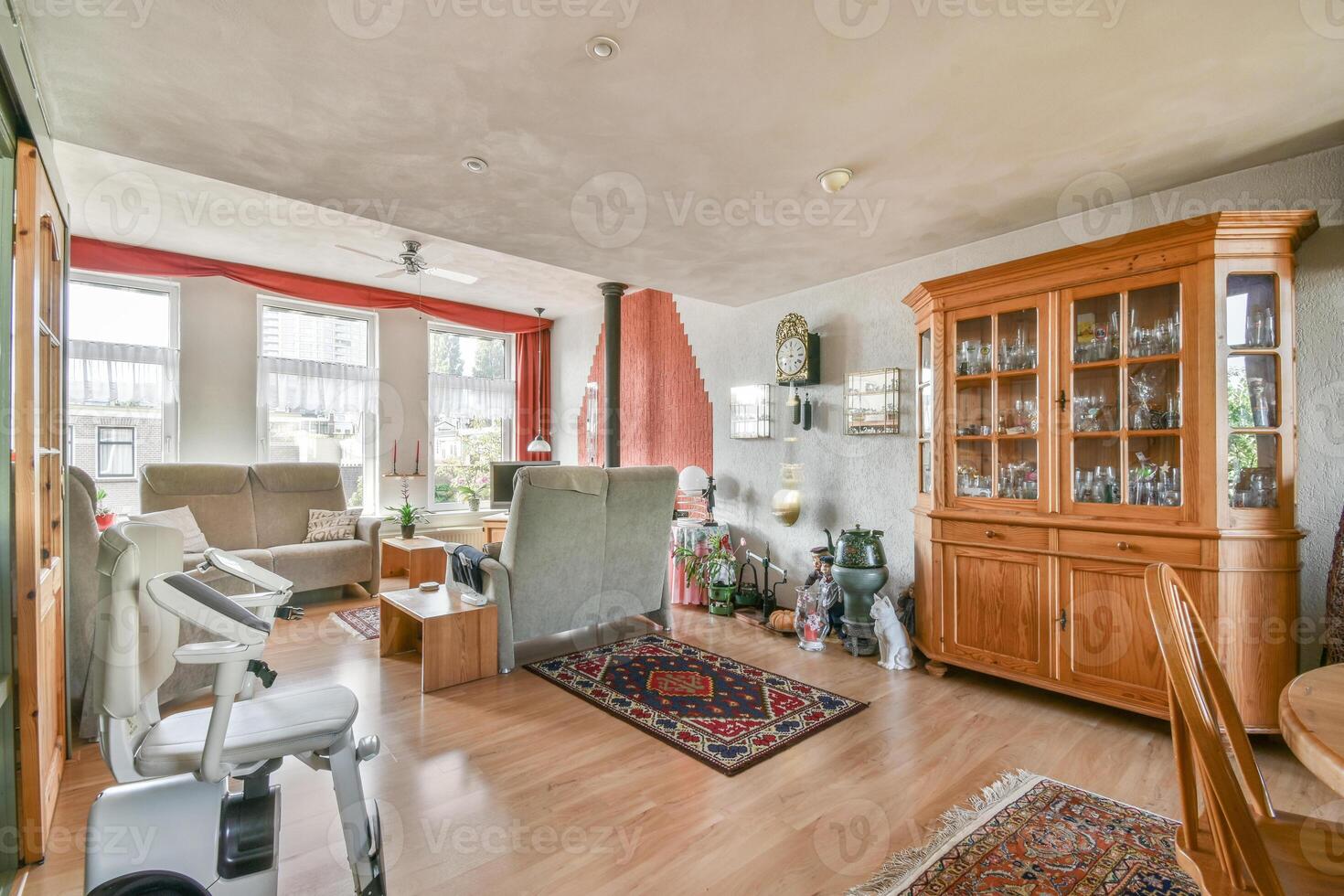 A living room with a wooden floor and a wooden cabinet photo