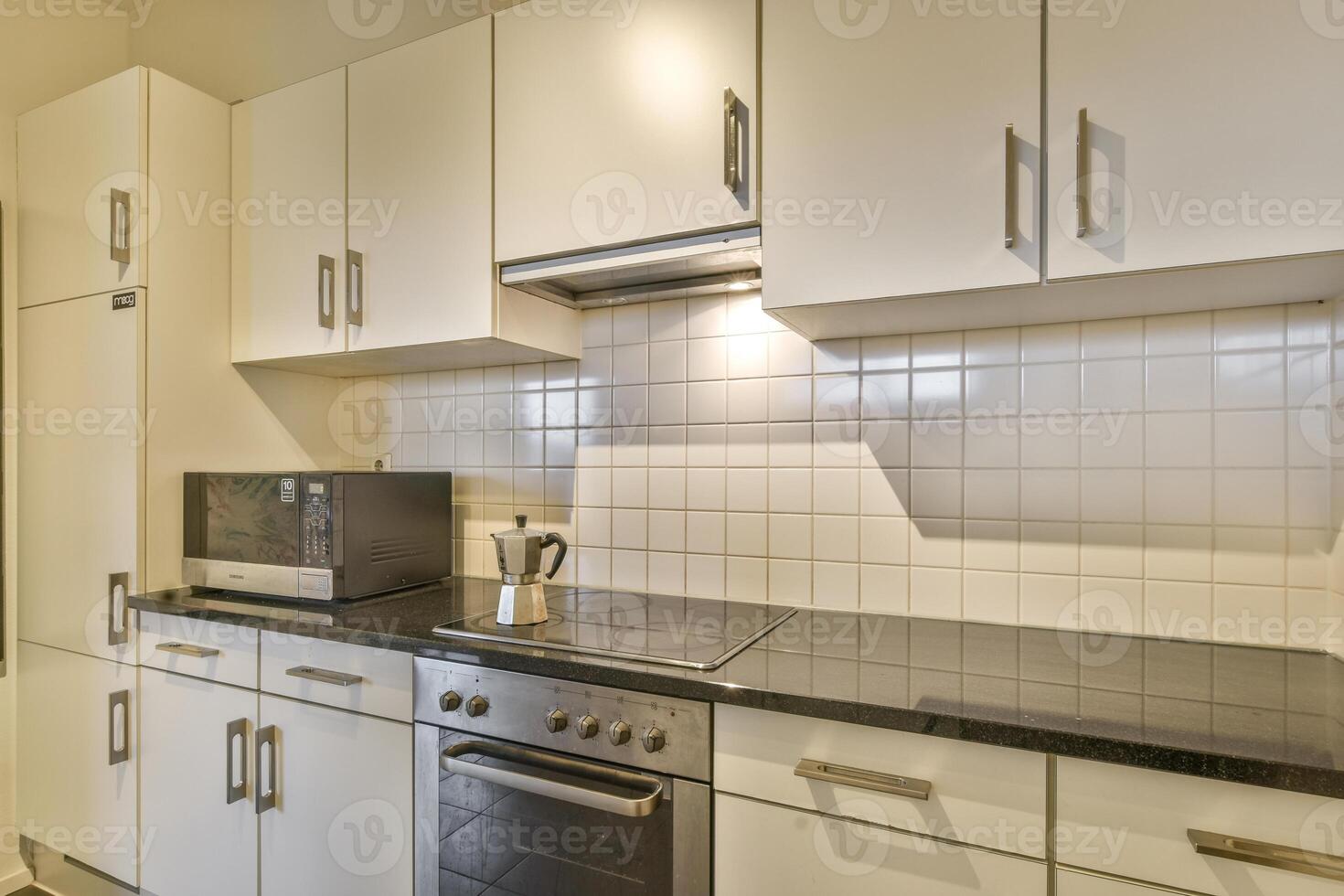 A kitchen with a microwave oven and a stove photo