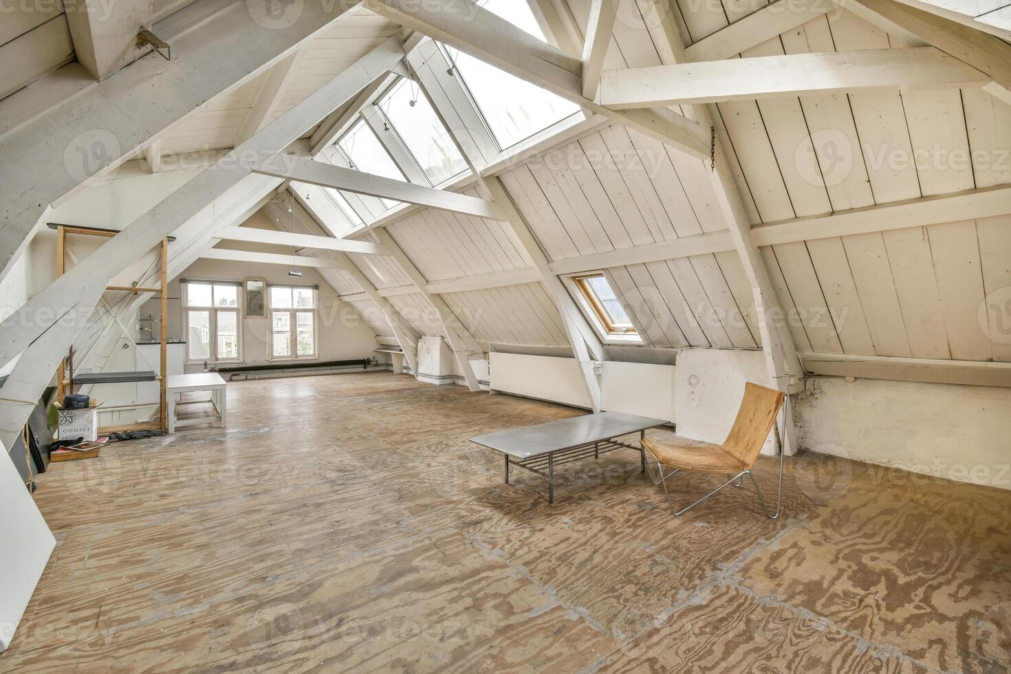 An empty loft with wooden floors and a wooden table photo