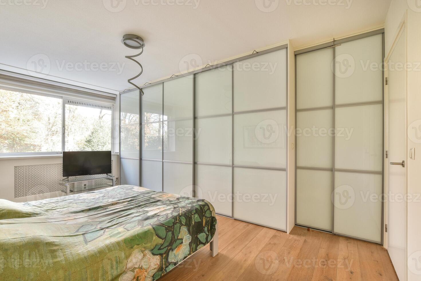 A bedroom with a bed and a television in it photo
