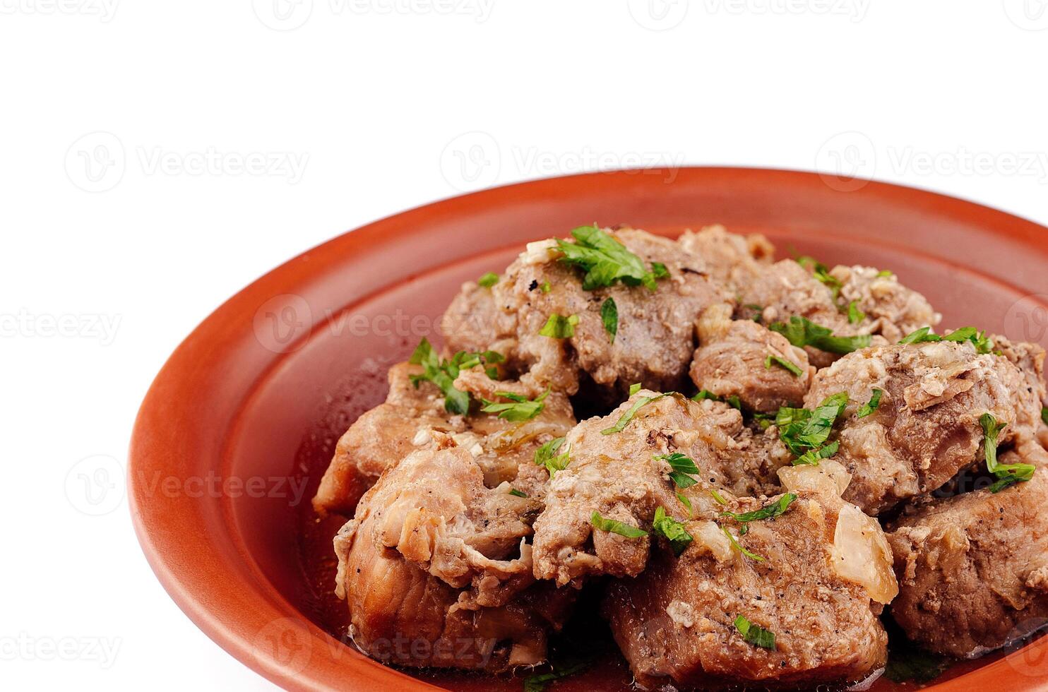Stewed pork meat with herbs and spices on a plate photo