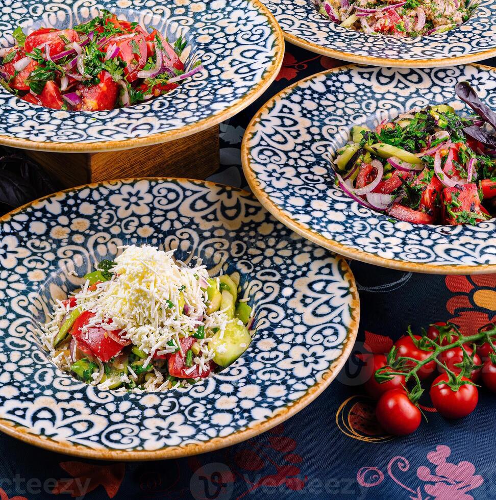 Plates with traditional bulgarian shopska salad on restaurant table setting photo