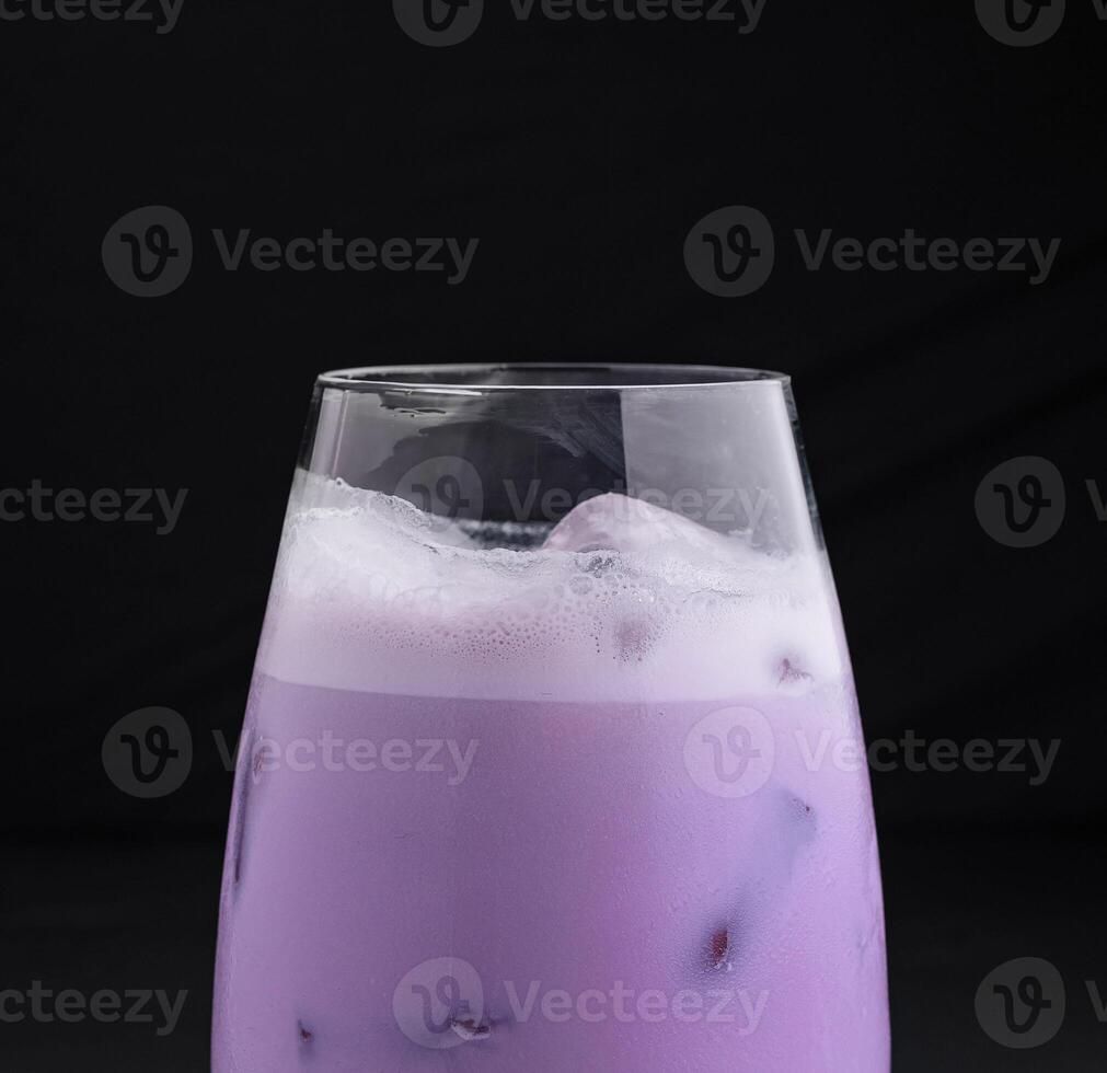 Purple taro bubble tea standing on dark background photo