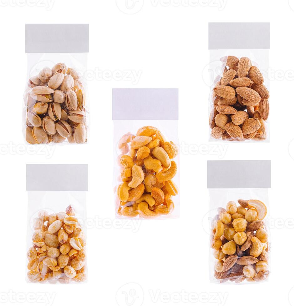 Different nuts and seeds packed in transparent bags with blank label for branding mockup photo