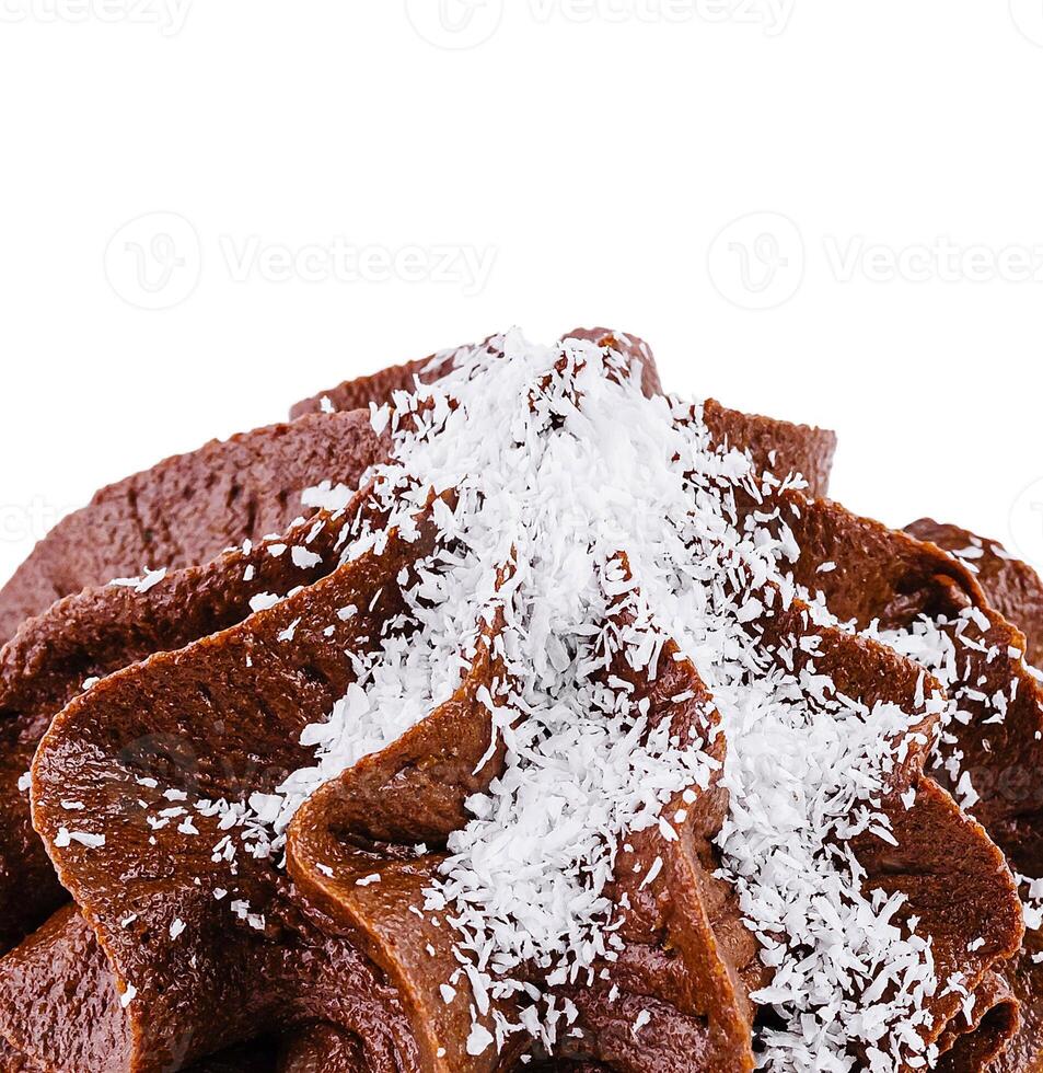 Delicious chocolate cupcake topping being sprinkled with coconut flakes photo