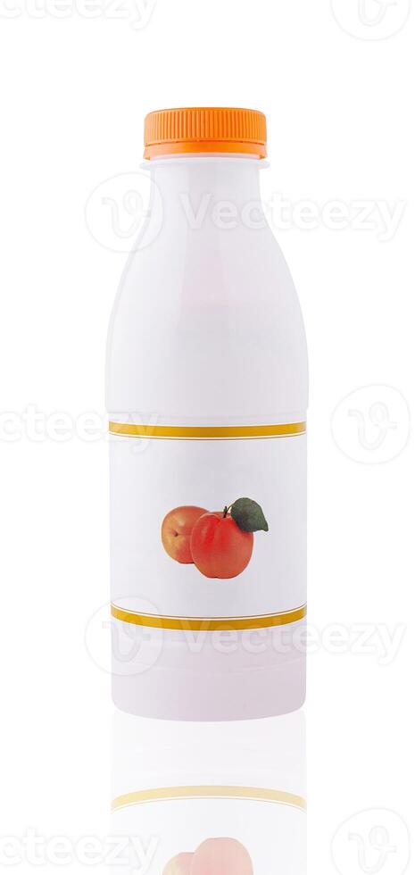 White plastic bottle with orange cap showing apricots on label is standing photo