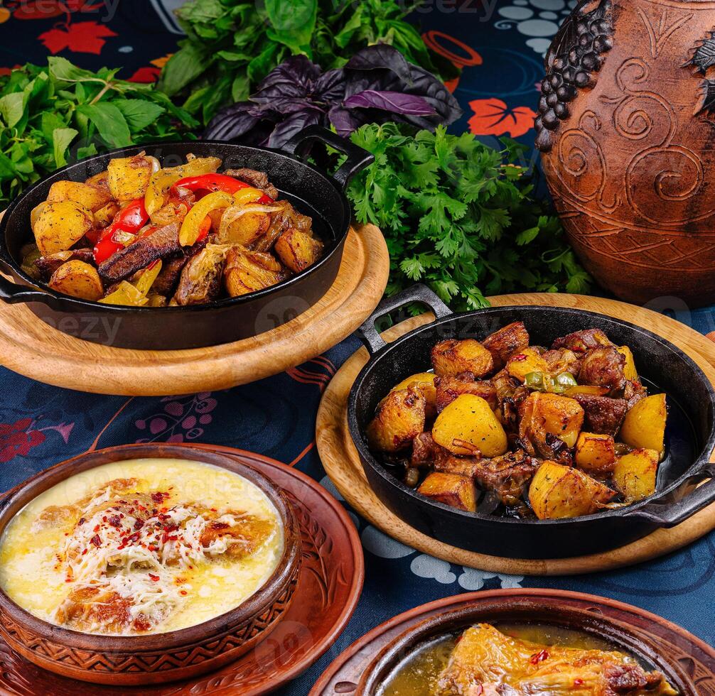 Georgian cuisine dishes with vegetables and herbs on blue tablecloth photo