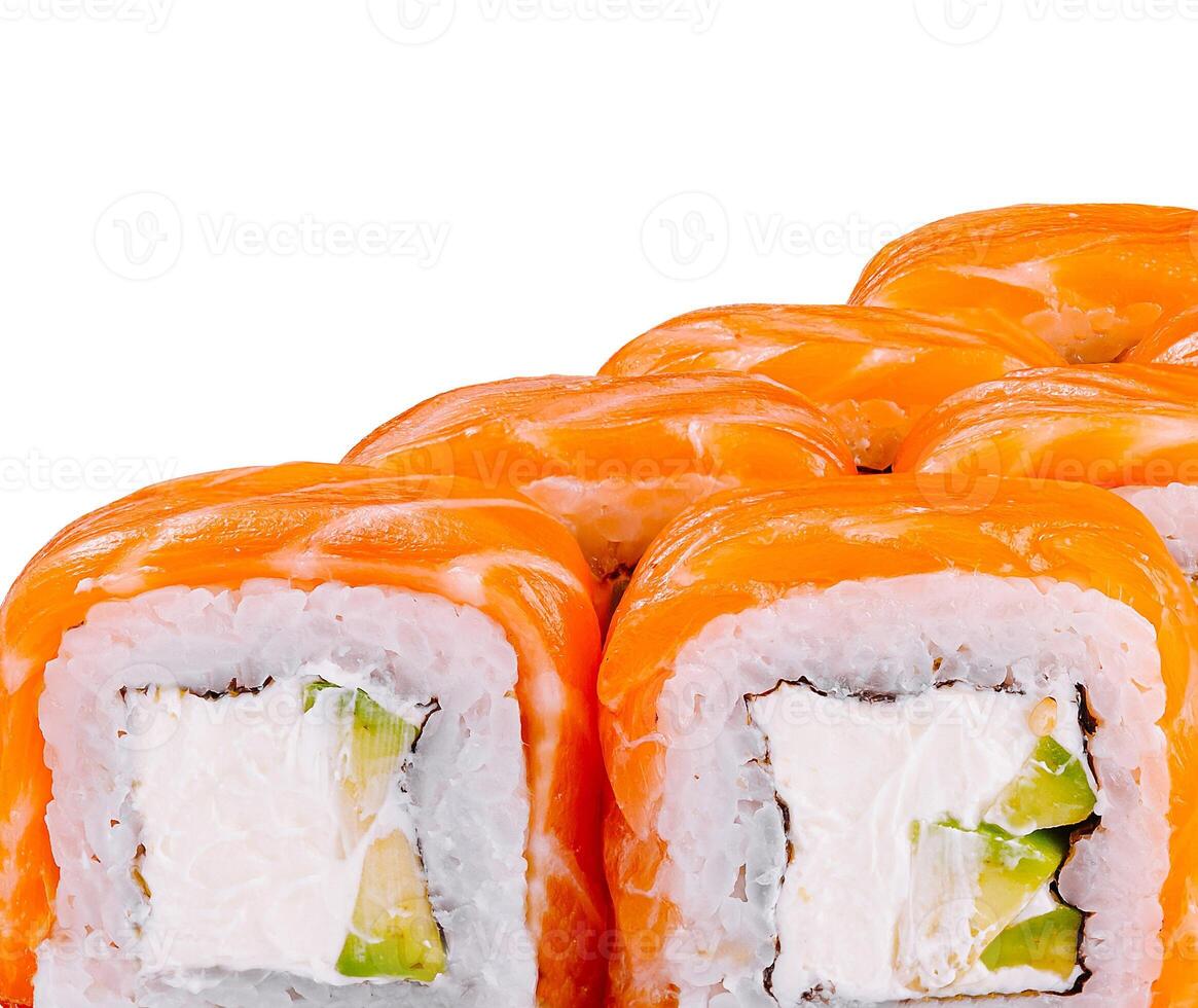 Philadelphia sushi rolls covered with salmon slices are lying in a row on white background photo