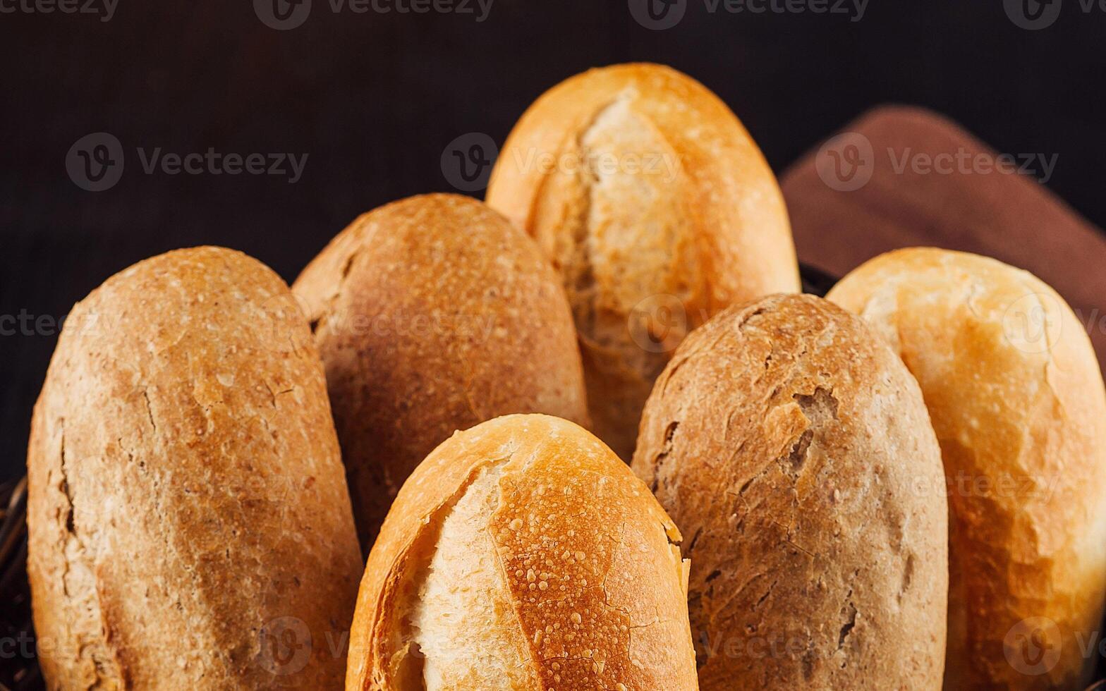 Freshly baked bread rolls resting in a basket photo