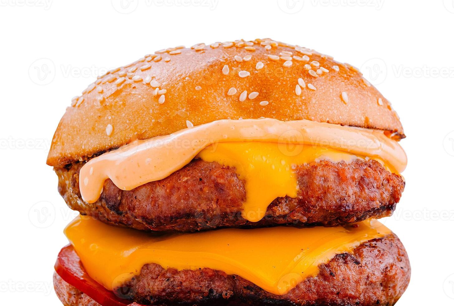Delicious burger with melted cheese and sauce dripping down photo