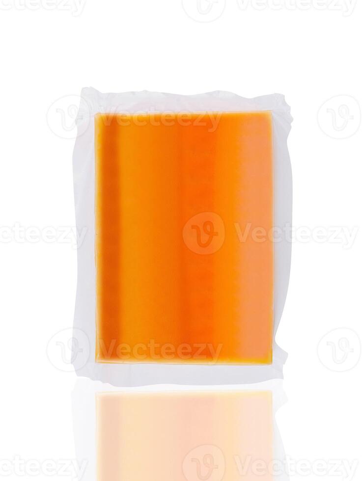 Vacuum packed block of cheddar cheese isolated on white background photo