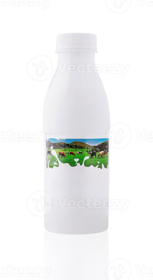 White plastic bottle of milk with cow grazing label on white background photo