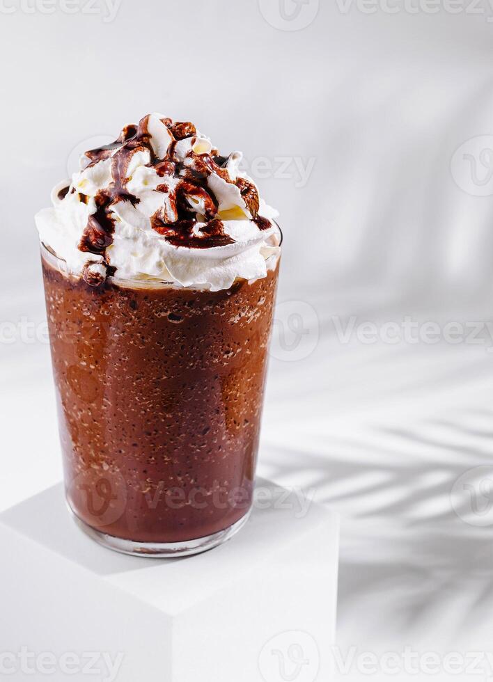 Delicious iced chocolate frappe with whipped cream and chocolate sauce on white background photo