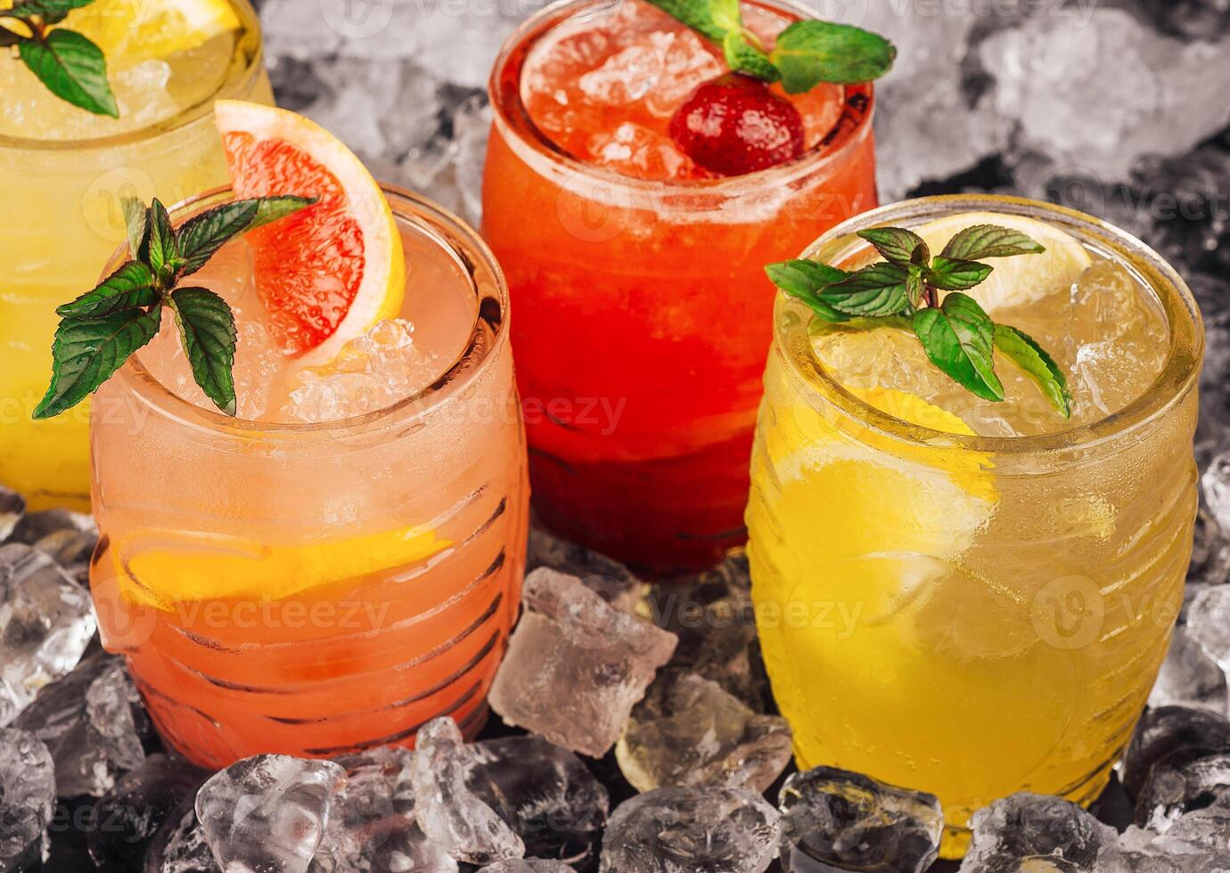 Refreshing summer cocktails resting on ice with mint garnish photo