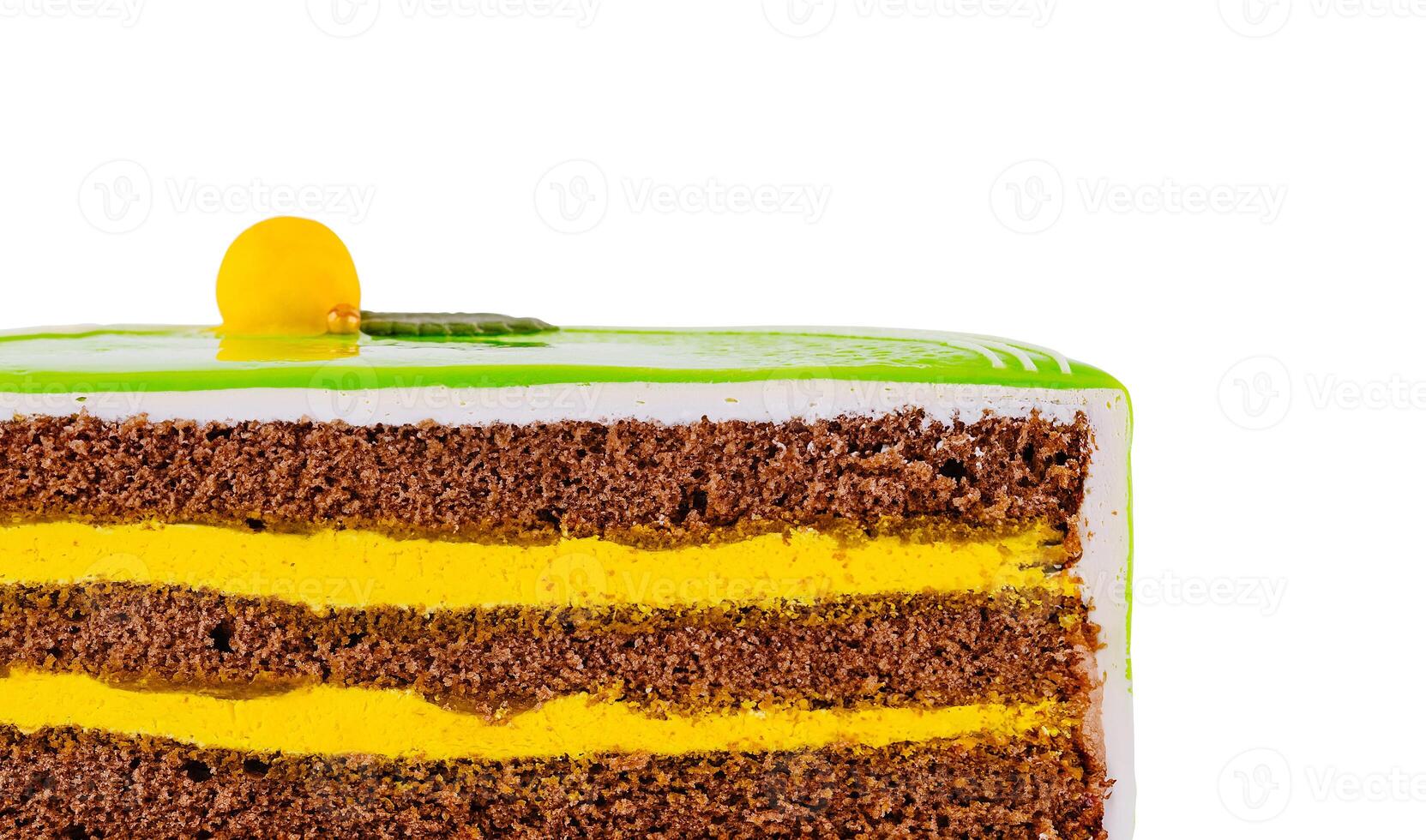 Delicious square cake with green icing and yellow filling showing its layers photo