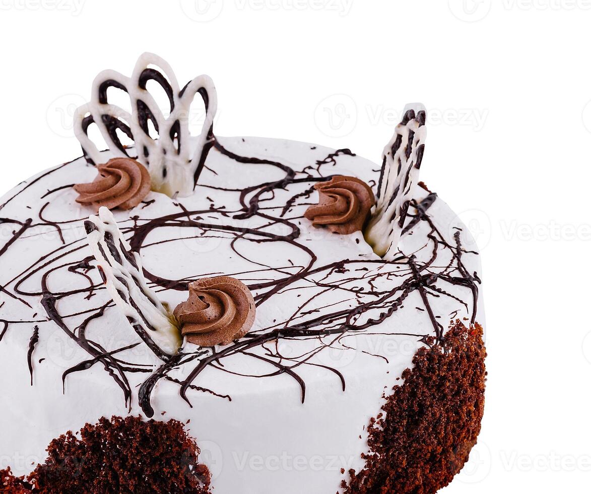 Delicious round chocolate cake with white icing and chocolate decorations isolated on white background photo
