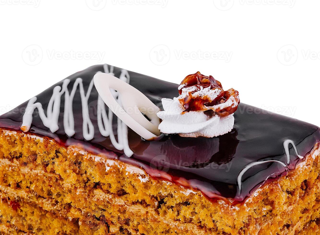 Delicious honey cake layered with chocolate glaze and topped with walnut and whipped cream photo