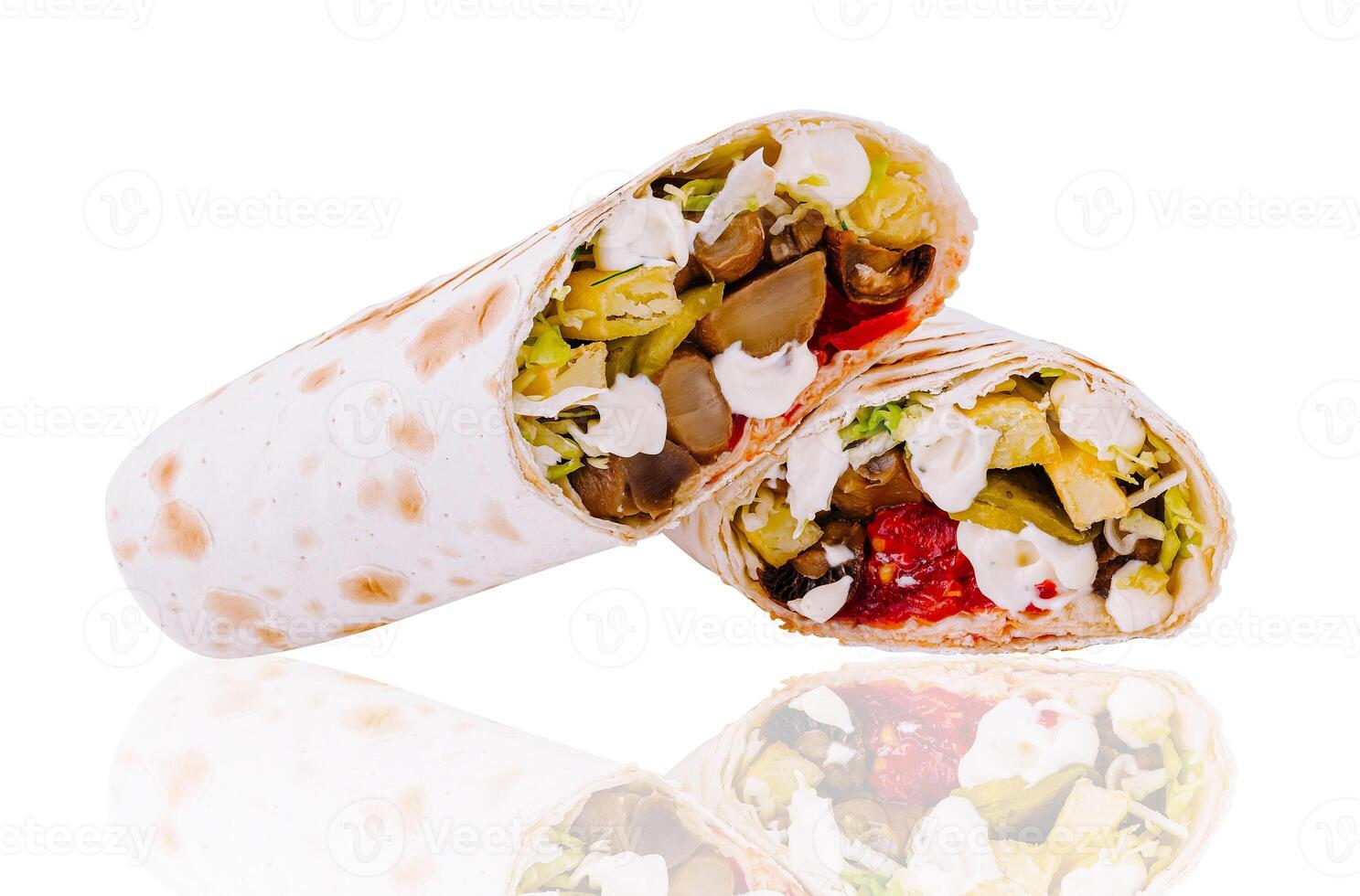 Two delicious vegetarian shawarma lying horizontally reflecting on white surface photo