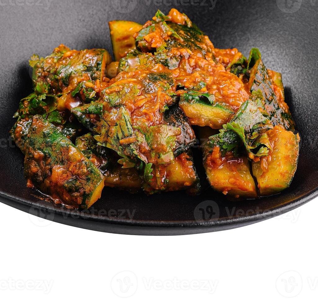 Spicy cucumber salad sprinkled with cilantro in black bowl photo
