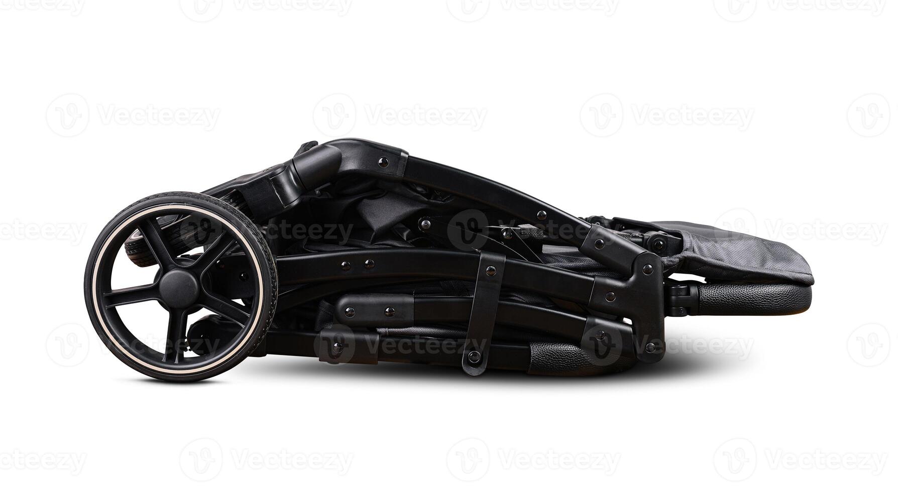Modern black baby stroller folded lying on white background photo