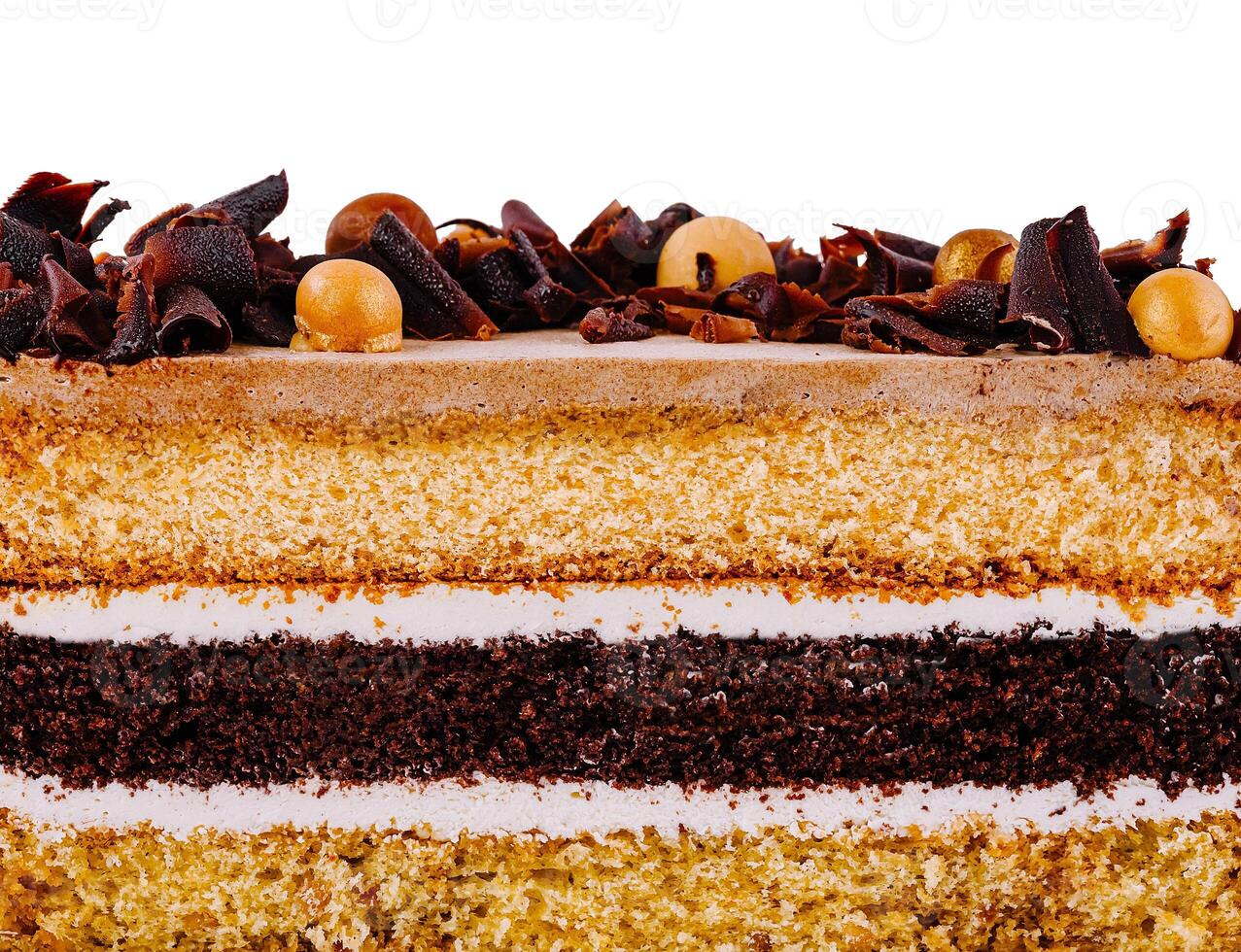 Delicious layered cake with chocolate curls and icing on white background photo