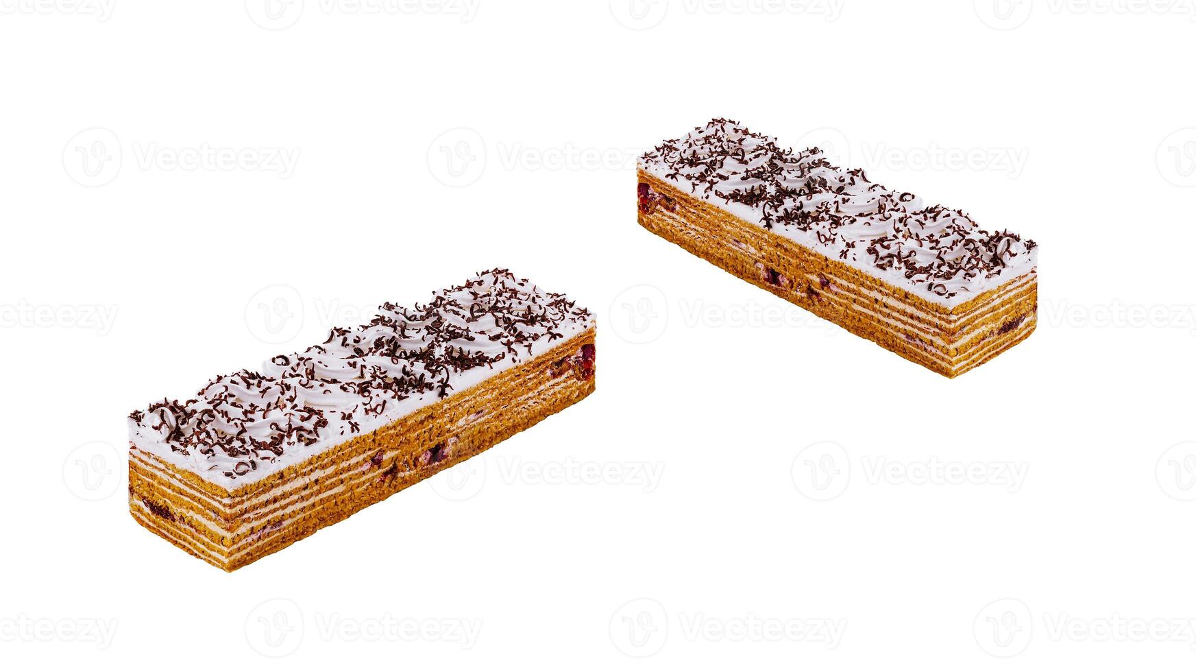 Delicious honey cake with cream and chocolate sprinkles isolated on white background photo