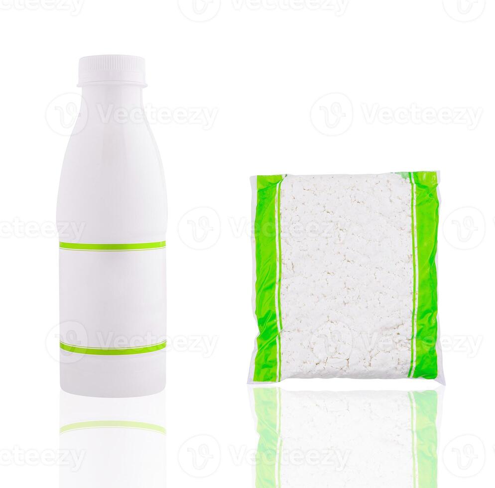 White plastic bottle and vacuum sealed bag with cottage cheese on white background photo