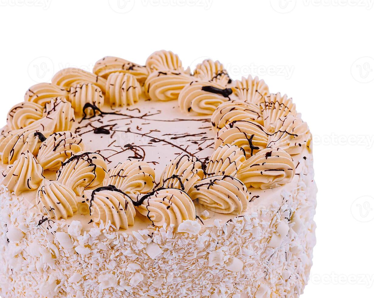 Delicious cake decorated with white chocolate shavings and buttercream piping photo