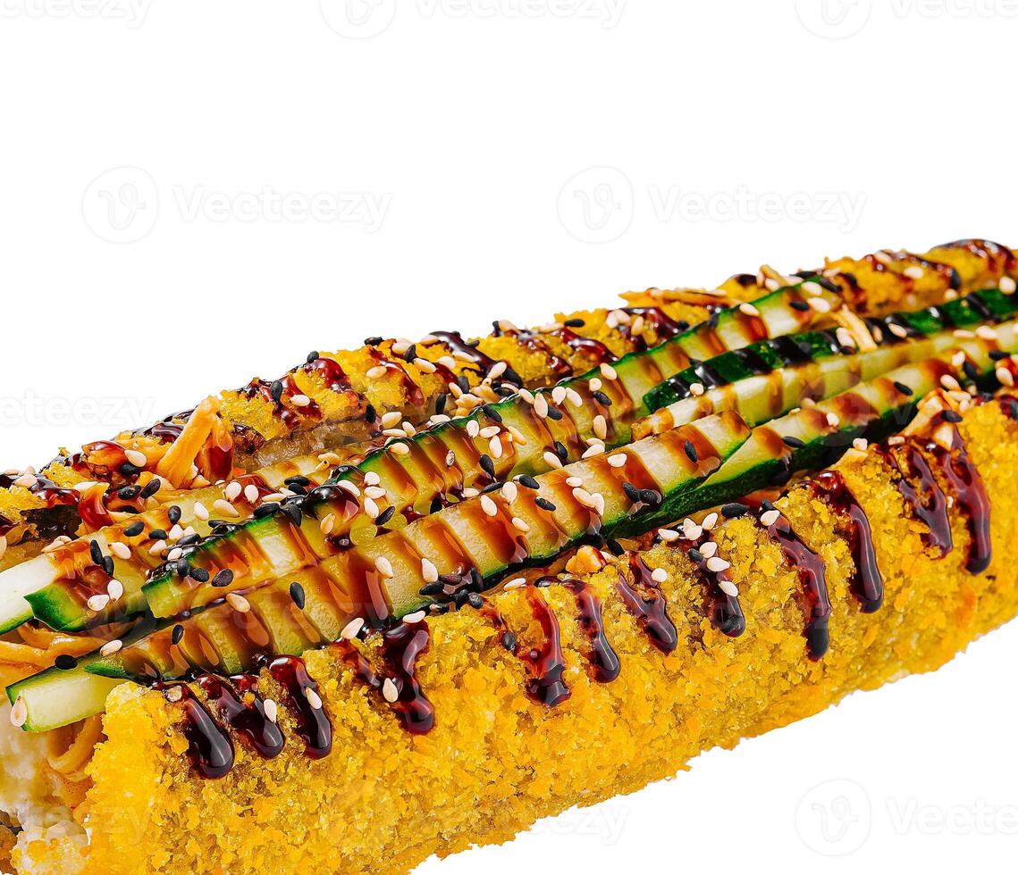 Tempura sushi roll topped with cucumber and sesame seeds on white background photo