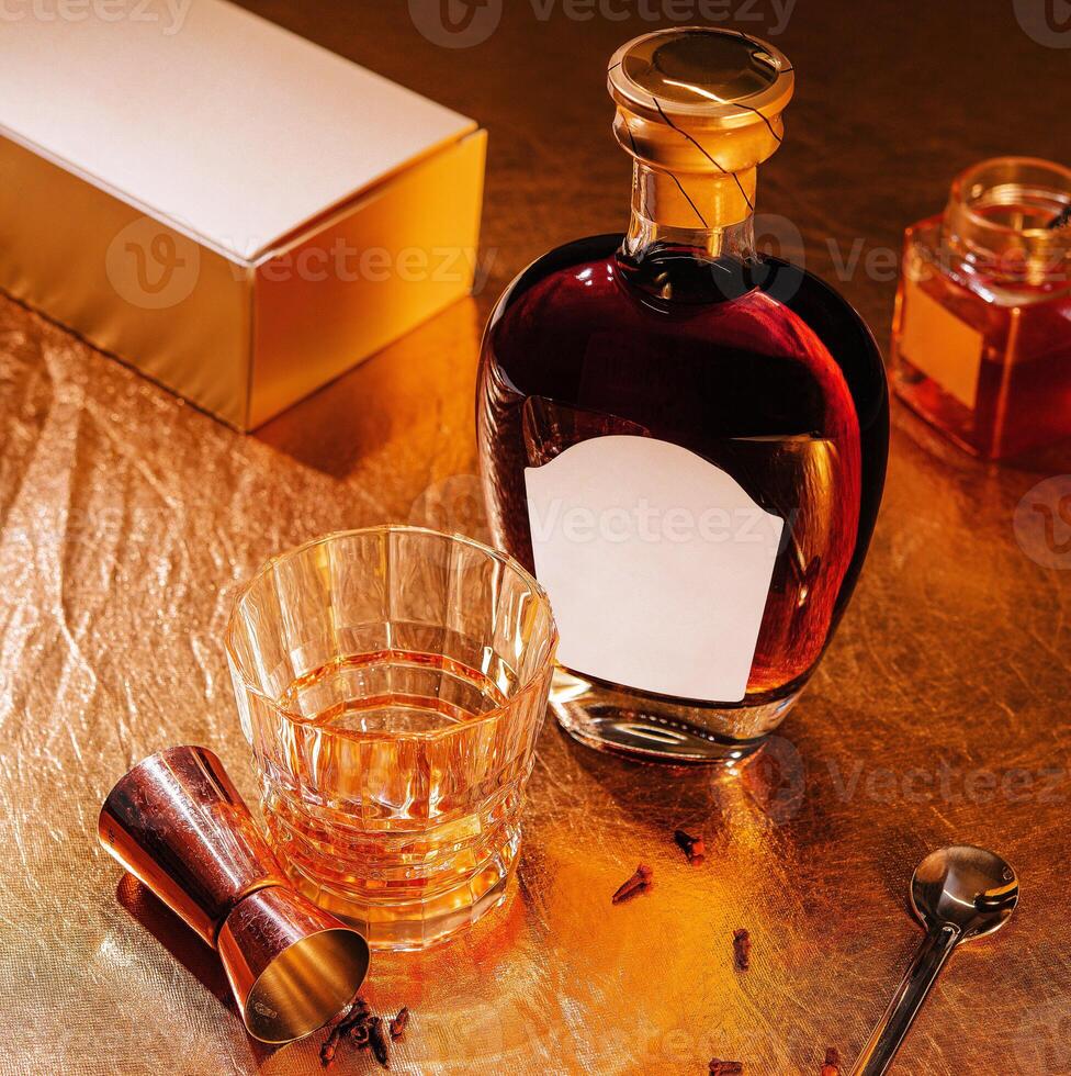 A bottle of whiskey and a glass with a spoon photo