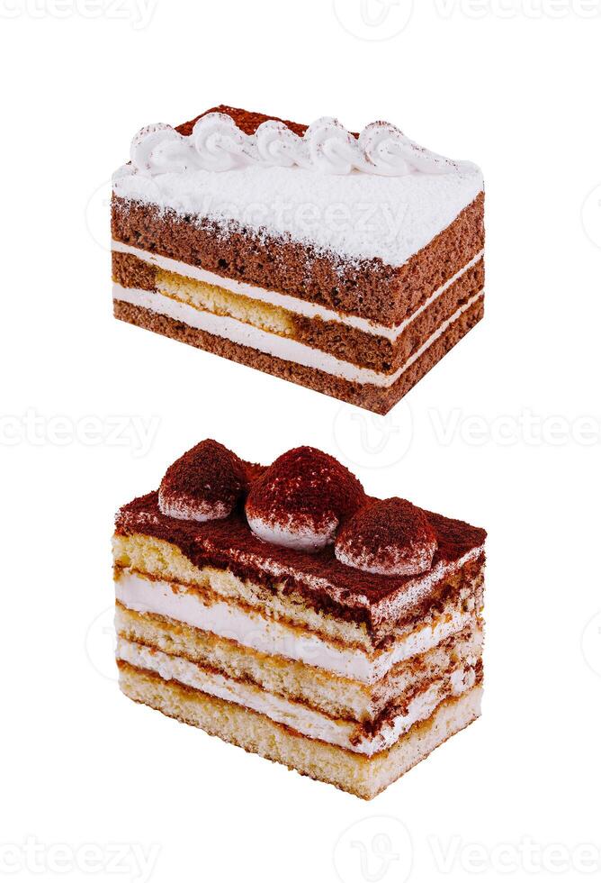 Two delicious slices of cake layered with cream filling on white background photo